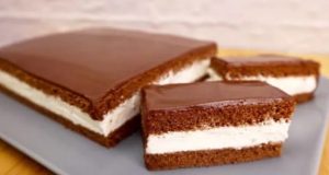 Delicate cocoa slices with creamy filling and fine chocolate icing