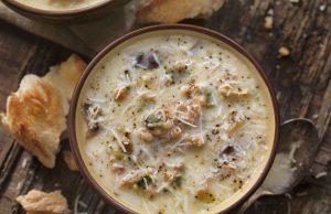Hearty potato and kale soup with sausage and parmesan cheese according to Italian recipe
