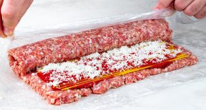 Delicious roulade of minced meat, tomato sauce and raw spaghetti