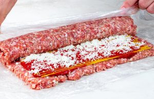 Delicious roulade of minced meat, tomato sauce and raw spaghetti