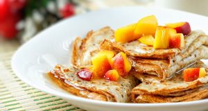 Wickedly good pancakes with peaches and cinnamon syrup