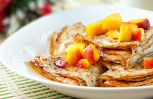 Wickedly good pancakes with peaches and cinnamon syrup