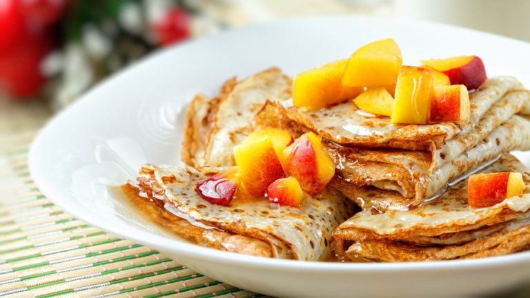 Wickedly good pancakes with peaches and cinnamon syrup