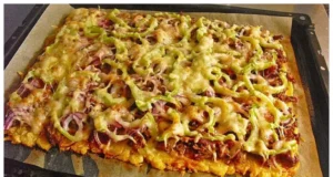 A coated potato pancake on a baking sheet, completely without flour