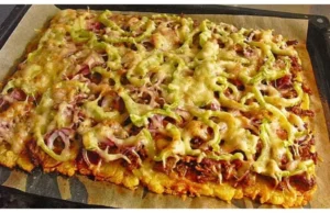 A coated potato pancake on a baking sheet, completely without flour