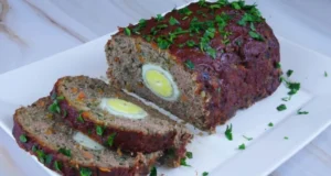 Baked roulade of ground beef with vegetables filled with egg