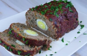 Baked roulade of ground beef with vegetables filled with egg