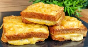 Baked Toasts from the Oven in an Egg Coat with Ham and Cheese Bread toasts filled with ham and cheese