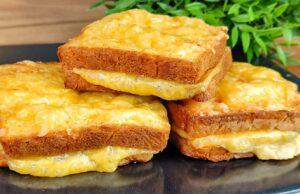Baked Toasts from the Oven in an Egg Coat with Ham and Cheese Bread toasts filled with ham and cheese