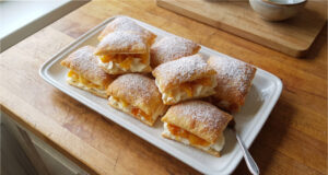 Apple Puff Pastries: Crispy Dessert with Delicate Mascarpone Cream Apple puff pastries with mascarpone cream on a plate
