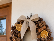 You Don’t Have to Buy an Autumn Wreath: 20 Pinecone Inspirations You Can Make at Home Autumn wreath made from pinecones with orange ribbon