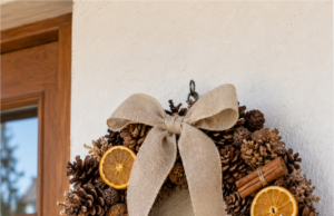 You Don’t Have to Buy an Autumn Wreath: 20 Pinecone Inspirations You Can Make at Home Autumn wreath made from pinecones with orange ribbon