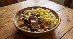 Beef Slices with Mushrooms: Slow-Braised Meat with a Delicate Cream Sauce Beef slices with mushrooms and creamy sauce served with dumplings