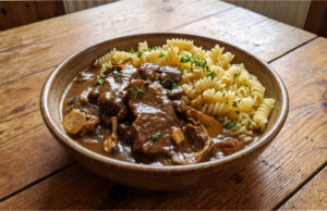 Beef Slices with Mushrooms: Slow-Braised Meat with a Delicate Cream Sauce Beef slices with mushrooms and creamy sauce served with dumplings
