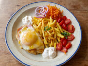 Chicken Breast with Ham, Cheese and Peach: A Retro Lunch with Fries Chicken breast with ham, cheese and peach served with fries