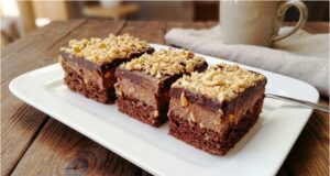 Nutty Chocolate Madness: Recipe for Luxurious Slices with Peanut Sponge, Egg Yolk Cream, and Glossy Glaze Nutty Chocolate Madness – luxurious slices with chocolate egg yolk cream and peanuts