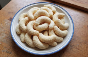 Coconut Crescents: Simple Christmas Cookies with a Delicate Flavor and Golden Finish Coconut crescents on a baking tray with a golden finish