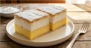 French Cream Slice with Flaky Puff Pastry, Airy Egg Yolk Cream, Rum and Whipped Cream French cream slice made from puff pastry with a tall layer of cream