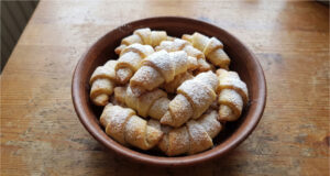 Delicate Filled Crescents: Soft Dough and Rich Walnut Filling Delicate filled crescents on a plate