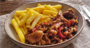Chicken Stir-Fry with Vegetables and Fries: Juicy Dinner with Asian Sauces Delicious chicken stir-fry with vegetables and homemade fries