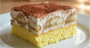 Whipped Cream Slices with Coffee Biscuits: A Delicate Dessert with a Hint of Tiramisu, Creamy Filling and Cocoa Coffee slices with biscuits and spreadable butter cream