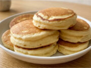 Recipe for Extra Fluffy Japanese Pancakes: Tall, Soft and Light as a Cloud Extra fluffy Japanese pancakes stacked on a plate with syrup and fruit