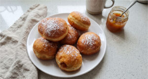 Fluffy Homemade Doughnuts with Jam: Soft Dough and Golden Surface Without Excess Oil Fluffy homemade doughnuts with jam on a plate