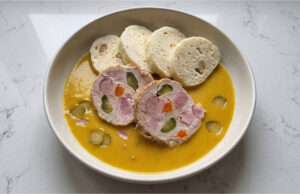 Hamburg Pork with Bread Dumplings: Traditional Sunday Lunch with Creamy Vegetable Sauce Hamburg pork with bread dumplings and creamy vegetable sauce served on a plate