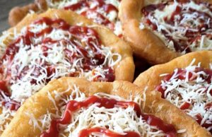 Homemade Langos from Yogurt Dough: Rise Overnight in the Fridge and Fluffy the Next Day Homemade langos from yogurt dough on a plate, topped with cheese and ketchup