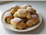 Homemade Poppy Seed Crescents: Soft Yeast Dough with a Rich Poppy Filling Homemade poppy seed crescents on a plate