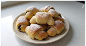 Homemade Poppy Seed Crescents: Soft Yeast Dough with a Rich Poppy Filling Homemade poppy seed crescents on a plate