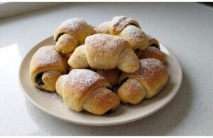 Homemade Poppy Seed Crescents: Soft Yeast Dough with a Rich Poppy Filling Homemade poppy seed crescents on a plate