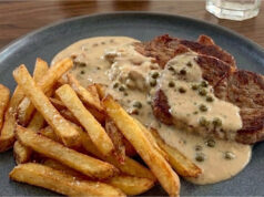 Juicy Pork Neck Steak with Green Pepper Sauce and Fries Juicy pork neck steak with green pepper sauce and homemade fries
