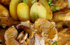 Luxurious Delicacy: Tender Pork Tenderloin in Creamy Mushroom Sauce with Roasted Potatoes Tender pork tenderloin in creamy mushroom sauce with crispy roasted potatoes