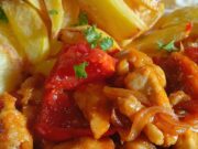 Tender Pork Strips in Curry Vegetable Sauce with Fragrant Roasted Potatoes Pork loin with vegetables and curry in a pan – juicy meat thanks to starch coating
