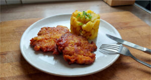 Pork Neck Meat Patties: Rested Overnight and Fried to Golden Perfection Golden pork neck meat patties with mashed potatoes and fried onions