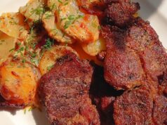 Juicy Pork Neck on Creamy Potatoes with Bacon, Onion and Baked Mozzarella Juicy pork neck with potatoes, bacon and mozzarella in a baking dish