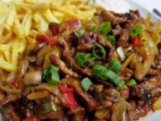 Pork Strips in One Pan: Juicy Meat with Vegetables, Mushrooms, and Crispy Fries Recipe for Chinese-style pork stir-fry with vegetables and fries