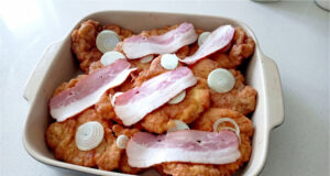 Reverse Schnitzels from Pork or Chicken: Crispy, Juicy, and Oven-Baked Reverse schnitzels with bacon and onion on a tray