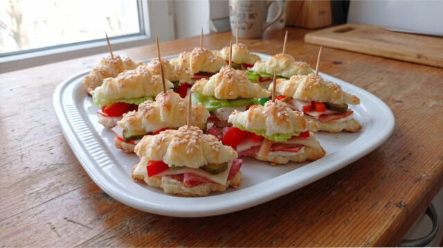 savory-mini-croissants-variation Variety of savory mini puff pastry croissants with different fillings on a serving tray