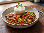 Spicy Beef Strips with Jasmine Rice: A Colorful Lunch Full of Vegetables and Bold Sauce Spicy beef strips with vegetables and jasmine rice served on a plate