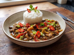 Spicy Beef Strips with Jasmine Rice: A Colorful Lunch Full of Vegetables and Bold Sauce Spicy beef strips with vegetables and jasmine rice served on a plate