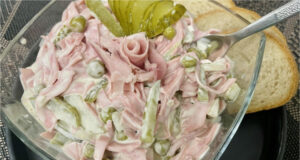 Traditional Homemade Delicacy Salad with Mayonnaise, Ham Sausage, and Vegetables Traditional delicacy salad – easy recipe with mayonnaise, vegetables and sausage