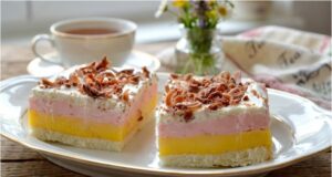 Creamy Tricolor Dessert: Recipe for a Three-Colored Delight with Meringue Base, Double Cream, and Whipped Cream Tricolor slices with vanilla and raspberry cream – festive dessert from egg whites