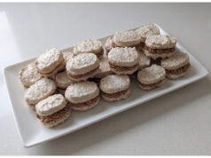 Homemade Walnut Meringue Shells: Delicate Snowy Shells with Smooth Parisian Cream Homemade walnut meringue shells with Parisian cream on a plate