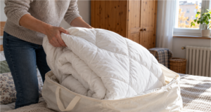 You Pulled Out Your Winter Duvet and It Smells Musty: When to Air It Out and When to Wash It Airing out a winter duvet on a drying rack