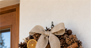 You Don’t Have to Buy an Autumn Wreath: 20 Pinecone Inspirations You Can Make at Home Autumn wreath made from pinecones with orange ribbon