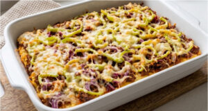 Baked Potato Pancake Without Frying: Crispy Treat for the Whole Family Baked potato pancake with cheese and vegetables on a tray