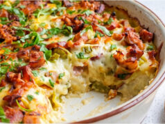 Baked Potatoes with Sausage: Hearty Dinner or Lunch with Mozzarella and Delicate Egg Sauce Baked potatoes with sausage, mozzarella and creamy egg sauce in a baking dish