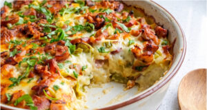 Baked Potatoes with Sausage: Hearty Dinner or Lunch with Mozzarella and Delicate Egg Sauce Baked potatoes with sausage, mozzarella and creamy egg sauce in a baking dish